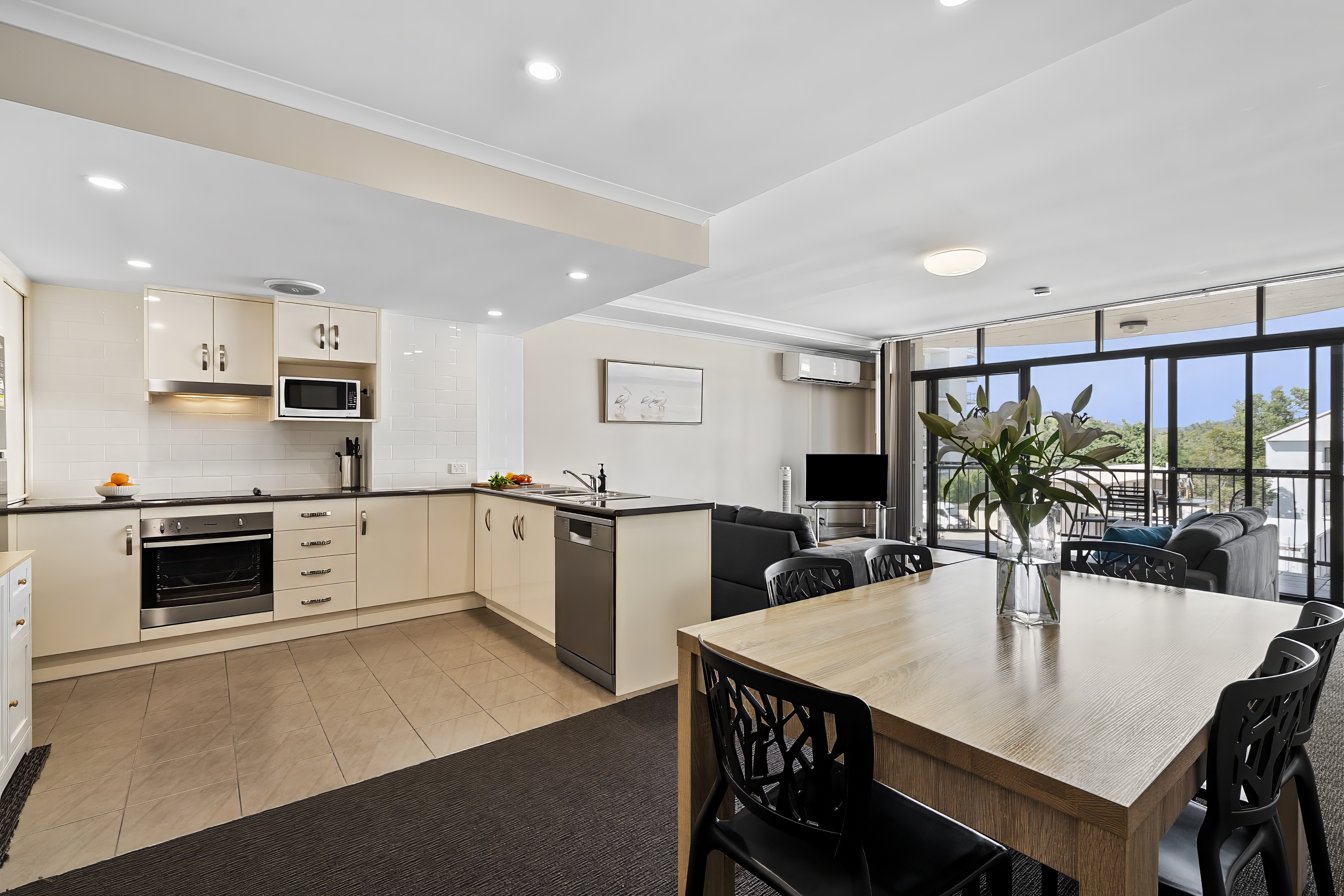 Open-plan kitchen and dining at Cityville's 3 Bedroom Executive Apartment